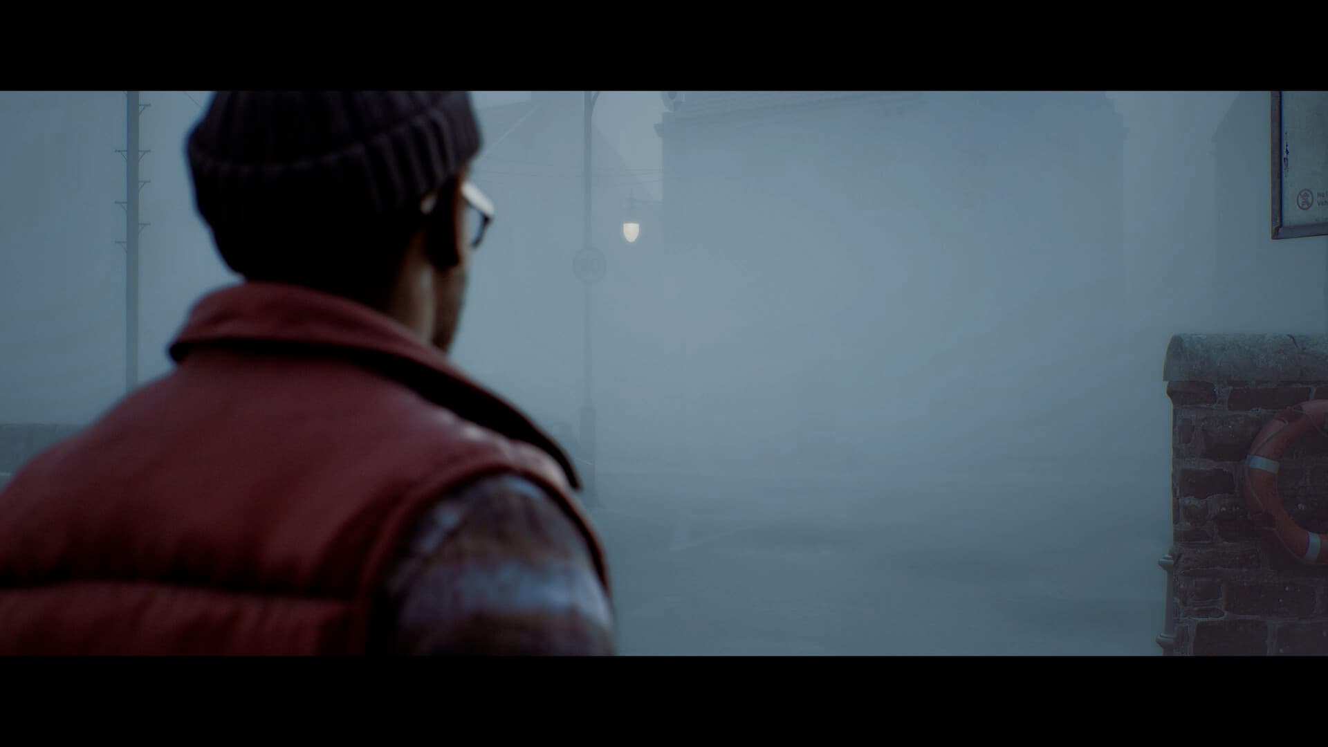 Simon faces a fog-covered shorefront street in SILENT HILL: Townfall
